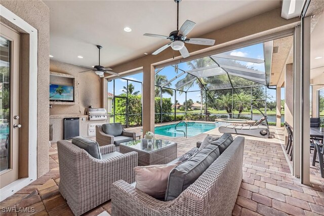 view of patio / terrace with ceiling fan, a grill, an outdoor living space, a lanai, and exterior kitchen