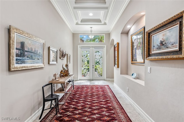 entryway featuring a high ceiling, ornamental molding, and french doors