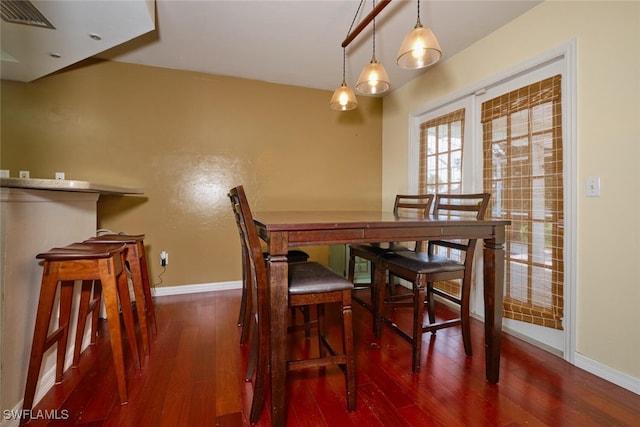 dining area with dark wood-type flooring