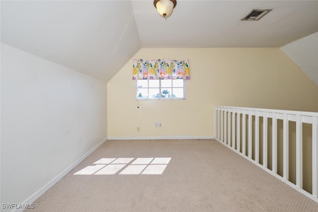 bonus room featuring vaulted ceiling and light carpet