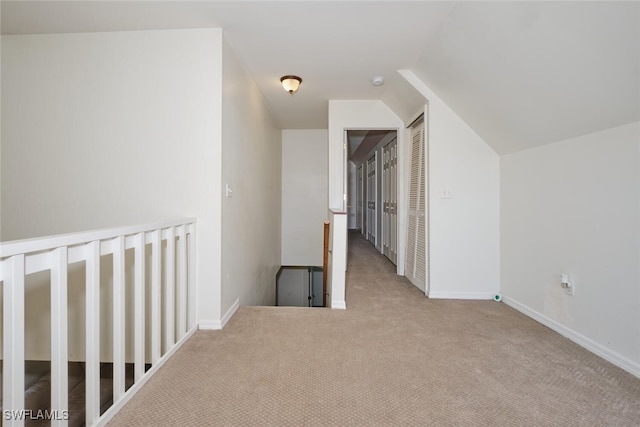 bonus room with light carpet and lofted ceiling