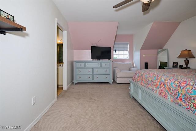 bedroom with lofted ceiling, ceiling fan, light colored carpet, and ensuite bathroom