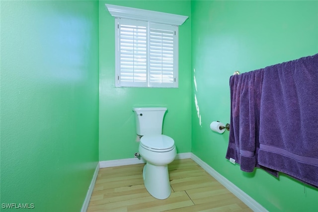 bathroom with hardwood / wood-style floors and toilet