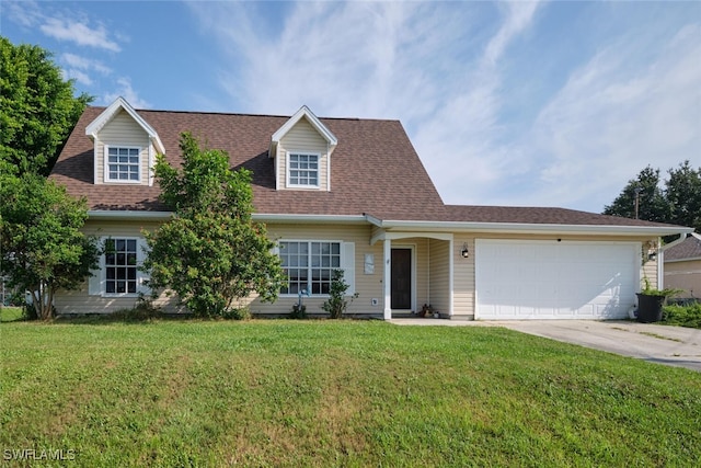 view of front of house with a front yard and a garage