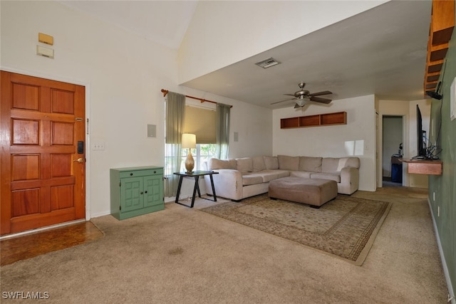 carpeted living room with lofted ceiling and ceiling fan