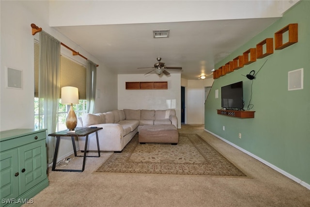 carpeted living room with ceiling fan