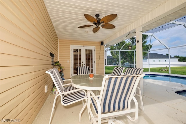 view of patio featuring glass enclosure and ceiling fan