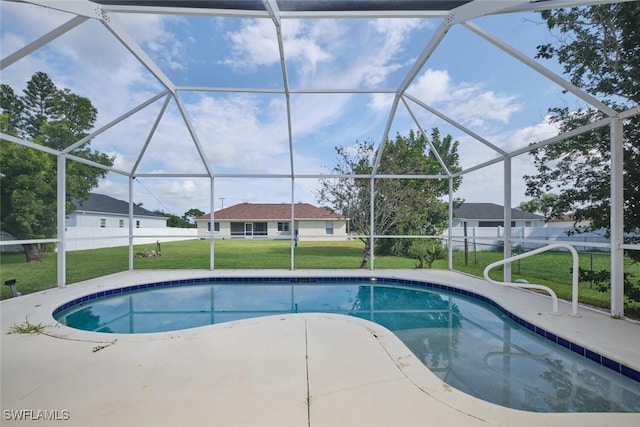 view of pool featuring a lawn, a patio area, and glass enclosure