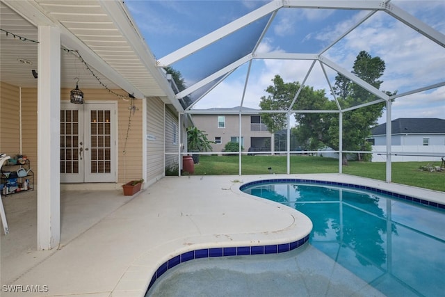 view of pool featuring french doors, glass enclosure, a patio, and a lawn