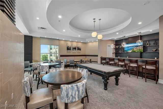 game room featuring bar area, light carpet, billiards, and a tray ceiling