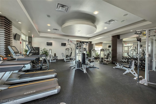 exercise room with a tray ceiling