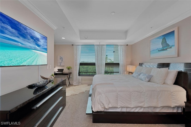 carpeted bedroom with a raised ceiling and ornamental molding