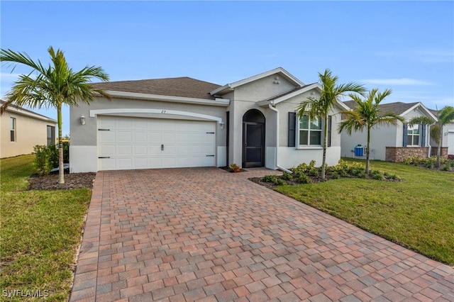 single story home with a garage and a front lawn