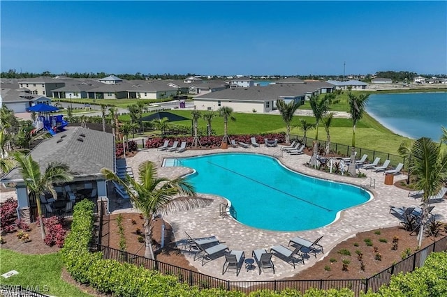 view of pool featuring a patio area and a water view