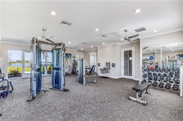 exercise room featuring crown molding, carpet, and ceiling fan