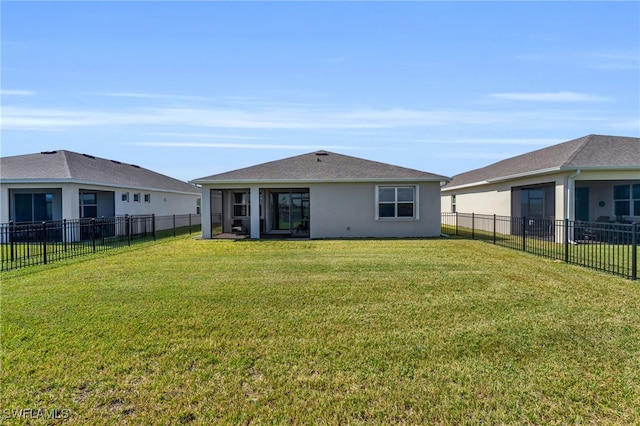 rear view of property with a yard and a sunroom