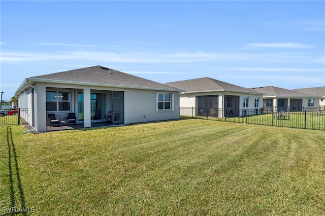 rear view of house featuring a patio and a lawn