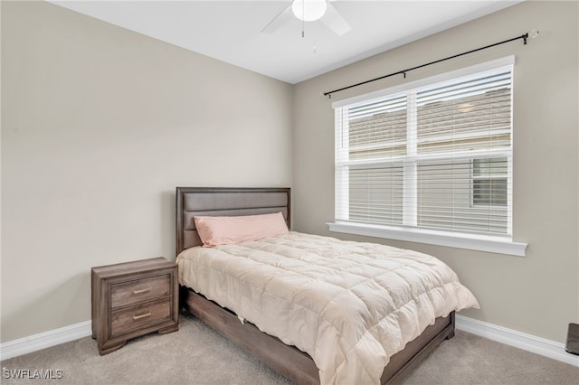 bedroom featuring light colored carpet and ceiling fan