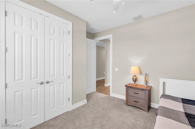 carpeted bedroom with a closet and ceiling fan