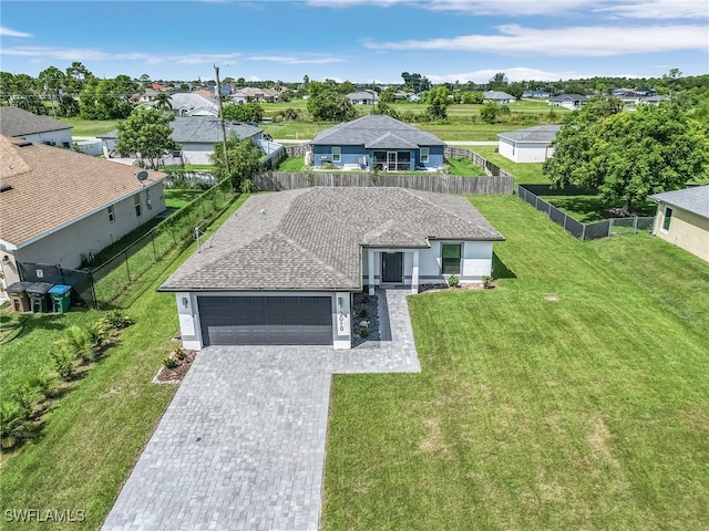 view of front facade featuring a front yard and a garage