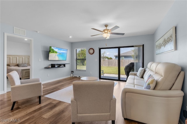 living room with ceiling fan and hardwood / wood-style floors