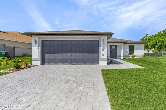 view of front facade featuring a front yard and a garage