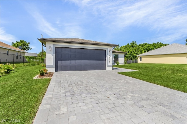 view of front of house with a garage and a front lawn