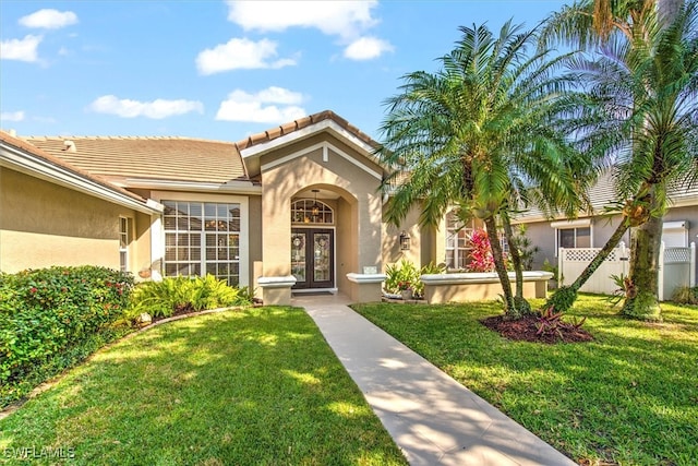 doorway to property with a lawn