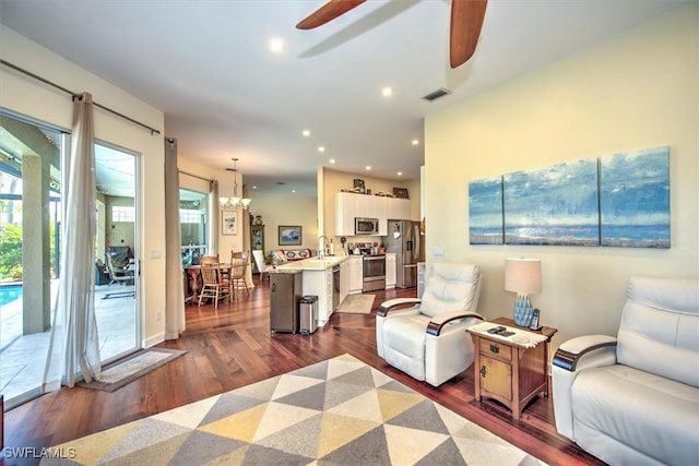 living room with ceiling fan, sink, plenty of natural light, and dark hardwood / wood-style floors