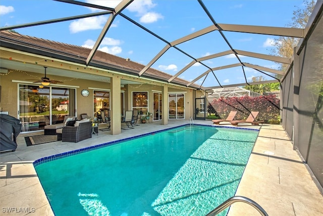 view of swimming pool with glass enclosure, outdoor lounge area, ceiling fan, and a patio area