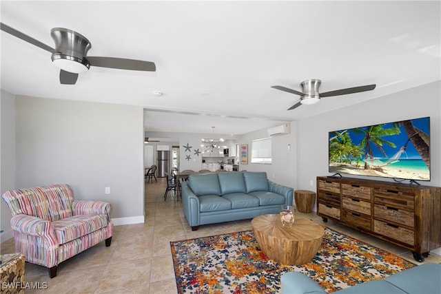 living room featuring ceiling fan with notable chandelier and light tile patterned floors