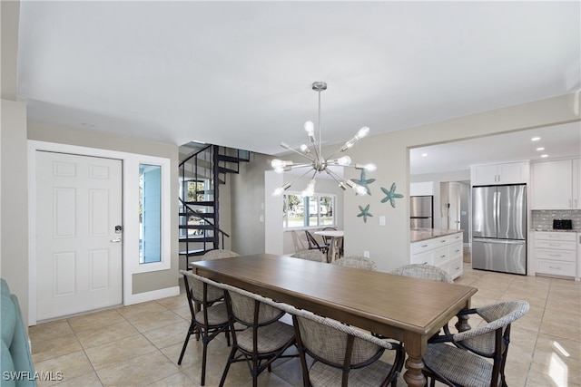 tiled dining space with a chandelier