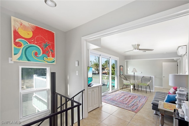 interior space featuring ceiling fan, light tile patterned floors, and a wall mounted AC