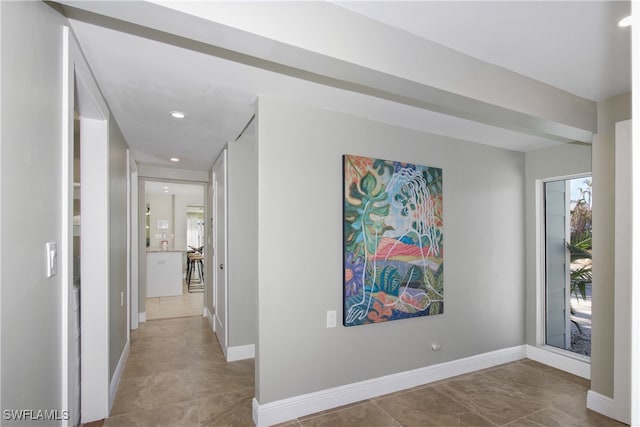 hall with light tile patterned floors