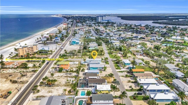 drone / aerial view with a beach view and a water view