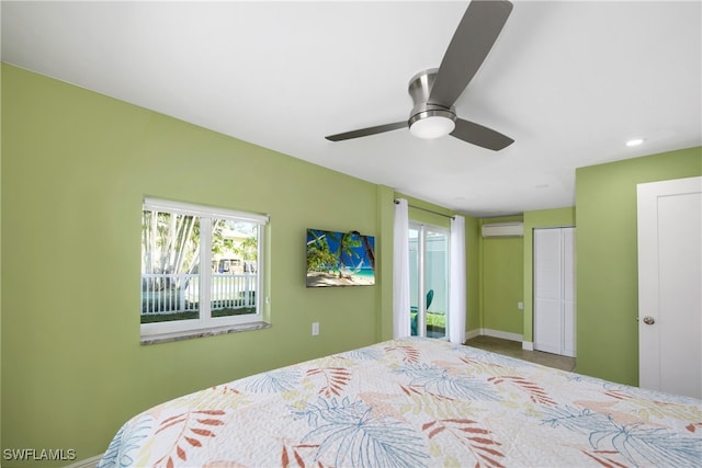 bedroom featuring an AC wall unit, ceiling fan, and a closet