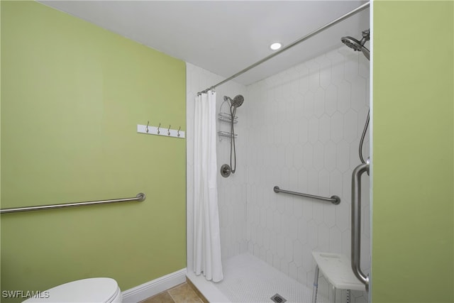 bathroom featuring walk in shower, tile patterned flooring, and toilet