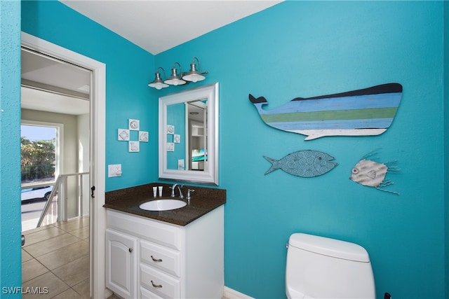 bathroom featuring tile patterned floors, vanity, and toilet