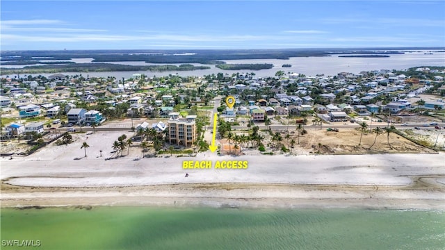 drone / aerial view featuring a water view and a beach view