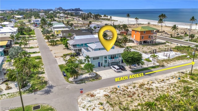 drone / aerial view featuring a water view and a view of the beach