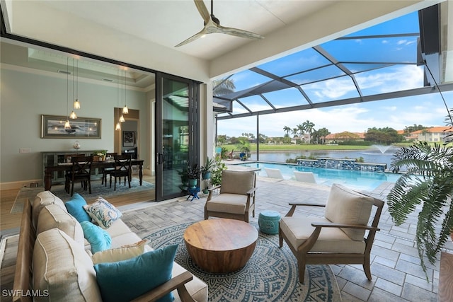 view of patio / terrace featuring a water view, ceiling fan, a lanai, an outdoor pool, and an outdoor living space