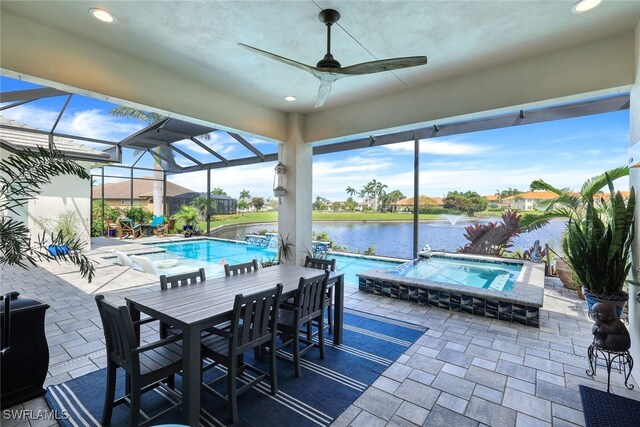 view of patio / terrace with a swimming pool with hot tub, a water view, glass enclosure, and ceiling fan