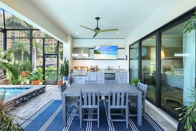 sunroom with ceiling fan and a sink