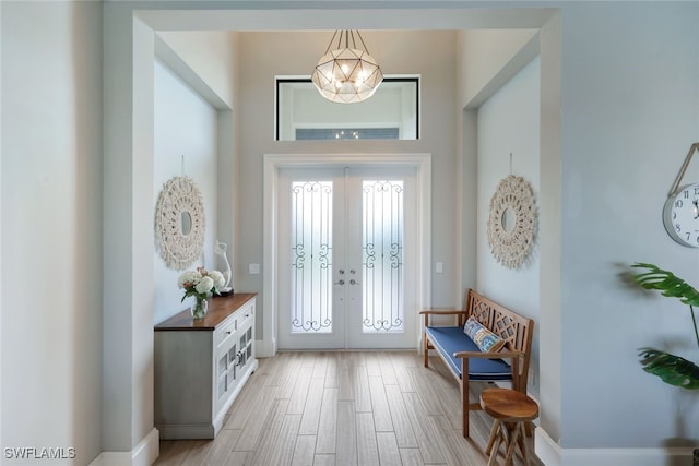 foyer entrance featuring light wood finished floors and french doors