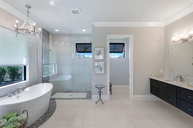 bathroom featuring baseboards, visible vents, a soaking tub, walk in shower, and vanity