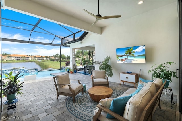 view of patio with outdoor lounge area, ceiling fan, a water view, and glass enclosure