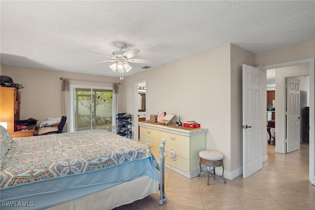 tiled bedroom featuring a textured ceiling and ceiling fan