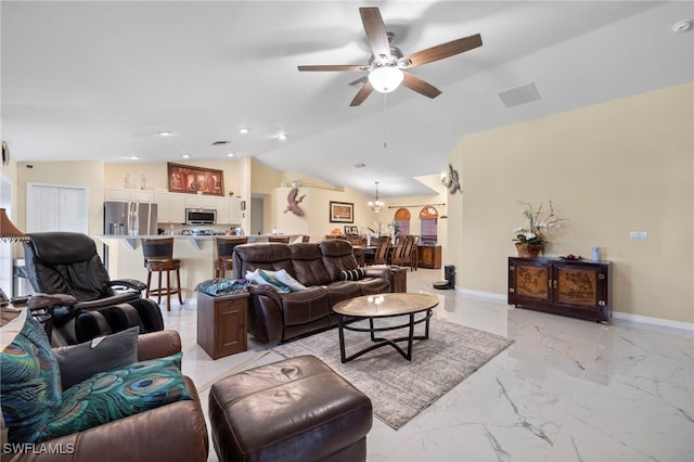 living room featuring ceiling fan and lofted ceiling