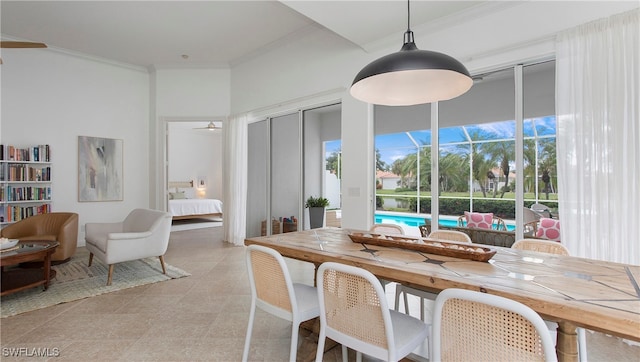 dining area with ceiling fan and crown molding