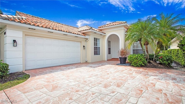 mediterranean / spanish house with a garage